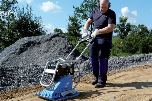 man using a compactor