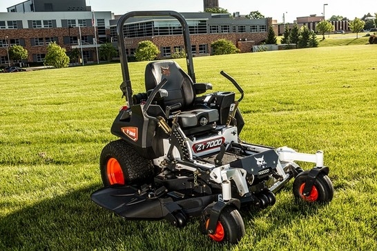 Stationary mower with property in background