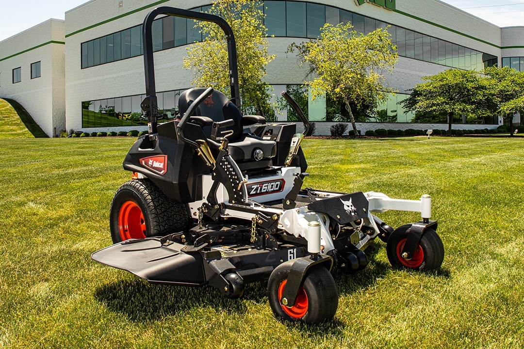 Stationary mower with building in background