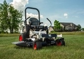 Mower sitting stationary with house in background